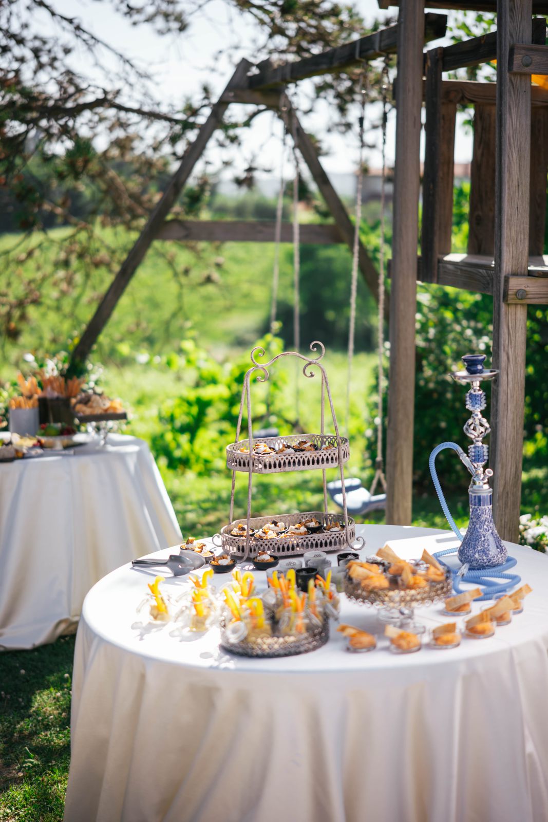 An outdoor buffet table set by Erica among the trees